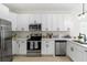 Well-equipped kitchen features stainless steel appliances and bright white cabinetry and countertops at 3508 E 11Th Ave, Tampa, FL 33605