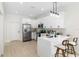 Bright kitchen features stainless steel appliances, white cabinets, and a breakfast bar with seating at 3508 E 11Th Ave, Tampa, FL 33605
