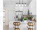 Bright kitchen features stainless steel appliances, white cabinets, and a breakfast bar with seating at 3508 E 11Th Ave, Tampa, FL 33605