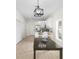 Open-concept kitchen and dining area with white cabinets, stainless appliances, and wood floors at 3508 E 11Th Ave, Tampa, FL 33605