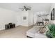 Open-concept living room featuring a ceiling fan, wood floors and gray sectional sofa at 3508 E 11Th Ave, Tampa, FL 33605