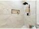 Luxurious walk-in shower boasts designer tile, a rainfall showerhead, and built-in niche at 3508 E 11Th Ave, Tampa, FL 33605