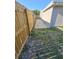 Home exterior alongside a fenced yard and narrow walkway at 3542 Trask Dr, Holiday, FL 34691