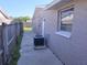 Exterior of home featuring an air conditioner and fenced walkway at 3542 Trask Dr, Holiday, FL 34691