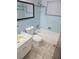 Full bathroom with blue tiling, vanity, toilet, and bathtub with shower at 3542 Trask Dr, Holiday, FL 34691