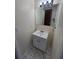 Bathroom features a single sink vanity with cabinet storage and a large mirror at 3542 Trask Dr, Holiday, FL 34691