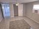 Spacious bedroom with tiled floors, ceiling fan, closet, and an air conditioning unit at 3542 Trask Dr, Holiday, FL 34691