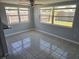 Cozy dining area featuring tile flooring and large windows with views of the backyard at 3542 Trask Dr, Holiday, FL 34691