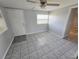 This entryway features neutral walls, updated tile flooring, a ceiling fan, and a window for natural light at 3542 Trask Dr, Holiday, FL 34691