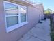 Exterior side view featuring stucco and white trimmed windows at 3542 Trask Dr, Holiday, FL 34691