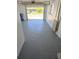 Spacious garage with smooth concrete floor and view to front yard at 3542 Trask Dr, Holiday, FL 34691