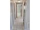 This hallway features tile flooring, neutral walls, a ceiling light and multiple doorways at 3542 Trask Dr, Holiday, FL 34691