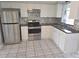 Well-equipped kitchen with stainless steel appliances and ample cabinet space at 3542 Trask Dr, Holiday, FL 34691