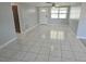 Spacious living room with tile flooring, a large window, and a welcoming atmosphere at 3542 Trask Dr, Holiday, FL 34691