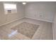 A spacious living room offers tile flooring, neutral walls, and a window air conditioning unit at 3542 Trask Dr, Holiday, FL 34691