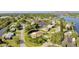 Aerial view of a home with lush landscaping, nestled in a waterfront community with canal access at 468 Ceil Dr, Nokomis, FL 34275