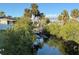 Picturesque backyard featuring a private dock surrounded by lush greenery and palm trees, offering serene waterfront access at 468 Ceil Dr, Nokomis, FL 34275
