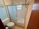Cozy bathroom features a shower-tub combination with a glass enclosure and tiled flooring at 468 Ceil Dr, Nokomis, FL 34275