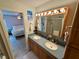 Bathroom with a double sink vanity, a large mirror, and shower at 468 Ceil Dr, Nokomis, FL 34275