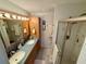 Bathroom featuring a double sink vanity, walk-in shower, and ample storage at 468 Ceil Dr, Nokomis, FL 34275