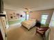 Comfortable bedroom featuring carpet, ceiling fan, and a large window for natural light at 468 Ceil Dr, Nokomis, FL 34275