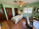 Bedroom featuring hardwood floors, ceiling fan and a double door closet at 468 Ceil Dr, Nokomis, FL 34275