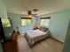 Bright bedroom with two windows, a ceiling fan, and carpet flooring at 468 Ceil Dr, Nokomis, FL 34275