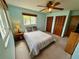 Comfortable bedroom with a ceiling fan and a window allowing natural light in at 468 Ceil Dr, Nokomis, FL 34275
