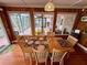 Inviting dining room with wood floors, a large window, and seating for six at 468 Ceil Dr, Nokomis, FL 34275