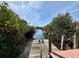 Waterfront views from this private dock, perfect for enjoying the serene canal and lush vegetation at 468 Ceil Dr, Nokomis, FL 34275