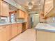 Bright kitchen with tiled floors, stainless steel appliances, and ample cabinet space at 468 Ceil Dr, Nokomis, FL 34275