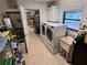 Bright laundry room with washer, dryer, sink, and storage cabinets at 468 Ceil Dr, Nokomis, FL 34275
