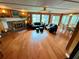 Spacious living room with wood floors, brick fireplace, and plenty of natural light at 468 Ceil Dr, Nokomis, FL 34275