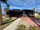 Enjoy the outdoors year-round on this home's large screened-in patio featuring a jacuzzi and lush landscaping at 468 Ceil Dr, Nokomis, FL 34275