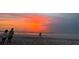 Breathtaking sunset over the ocean, with people enjoying the view on the sandy beach at 468 Ceil Dr, Nokomis, FL 34275