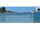 Scenic water view, featuring blue water, a partial view of a blue boat, and distant sailboats on the horizon at 468 Ceil Dr, Nokomis, FL 34275