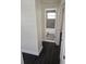 Hallway view of the bathroom with a white bathtub and a gray tiled wall behind it at 4823 Blossom Dr, Holiday, FL 34690