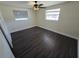 Inviting bedroom with neutral walls, wood-look floors, and a ceiling fan for comfort at 4823 Blossom Dr, Holiday, FL 34690