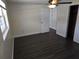 Comfortable bedroom featuring wood-look floors, a ceiling fan, and neutral paint at 4823 Blossom Dr, Holiday, FL 34690