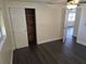 This bedroom features hardwood floors and a closet with white doors and stained wood inside at 4823 Blossom Dr, Holiday, FL 34690