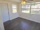 Bright and sunny Florida room features hardwood floors, a ceiling fan, and lots of light at 4823 Blossom Dr, Holiday, FL 34690