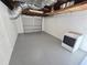 Open garage space with washer and overhead storage at 4823 Blossom Dr, Holiday, FL 34690