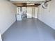 Spacious garage with utility sink, washer, and bathroom at 4823 Blossom Dr, Holiday, FL 34690