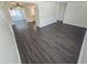 Open-concept living room and kitchen area with hardwood floors and white trim throughout at 4823 Blossom Dr, Holiday, FL 34690