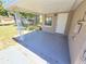 Covered outdoor patio with a concrete floor and access to the backyard at 4823 Blossom Dr, Holiday, FL 34690