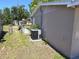 The home's side yard showing the air conditioning unit and access to the backyard at 4823 Blossom Dr, Holiday, FL 34690