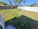 Spacious backyard with green grass and trees at 5014 Galaxy Dr, New Port Richey, FL 34652