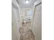 Compact bathroom features a toilet, sink, mirror, and neutral tile flooring at 5014 Galaxy Dr, New Port Richey, FL 34652
