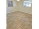 The airy bedroom features neutral walls, tile floors, and a ceiling fan at 5014 Galaxy Dr, New Port Richey, FL 34652