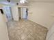 Bedroom featuring tile floor, neutral walls and access to an attached bathroom at 5014 Galaxy Dr, New Port Richey, FL 34652
